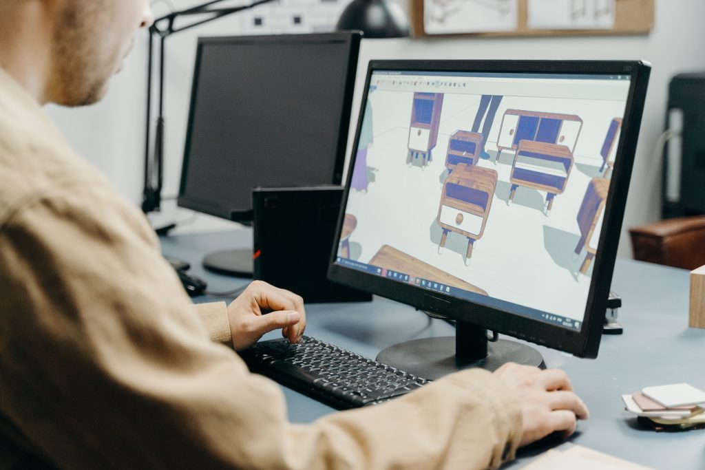 pexels photo 7504746 7504746 A product designer using a computer for 3D furniture modeling in an office setting.